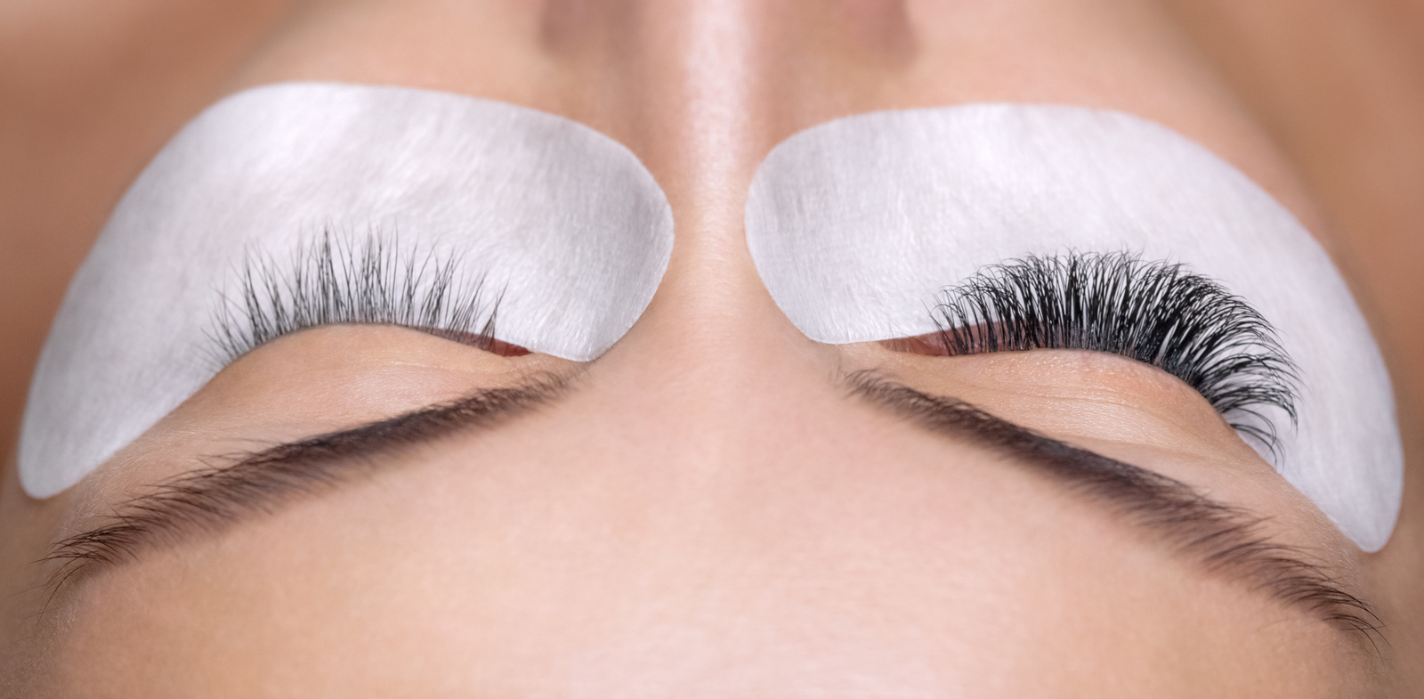 Eyelash removal procedure close up. Beautiful Woman with long lashes in a beauty salon.